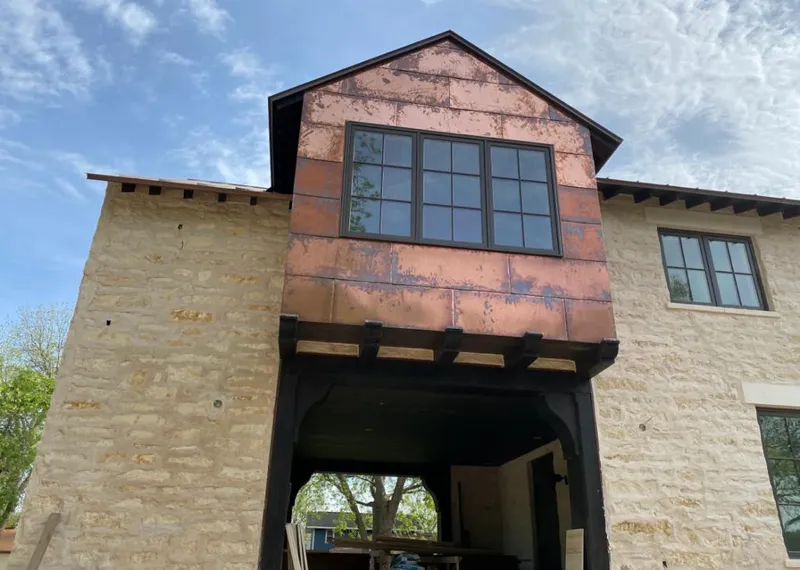 Copper metal panel facade on a stone building for Metal Roof Coating in Clanton
