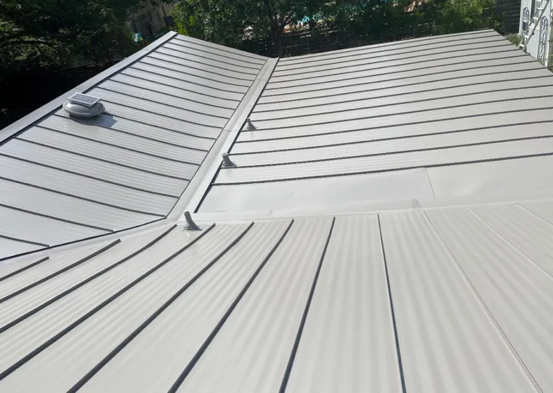 Solar attic fan installed on a metal roof for Roof Ventilation in Clanton